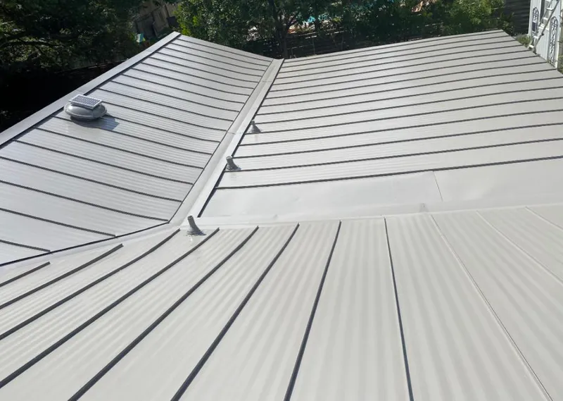 Solar attic fan installed on a metal roof for Roof Ventilation in Newington Forest