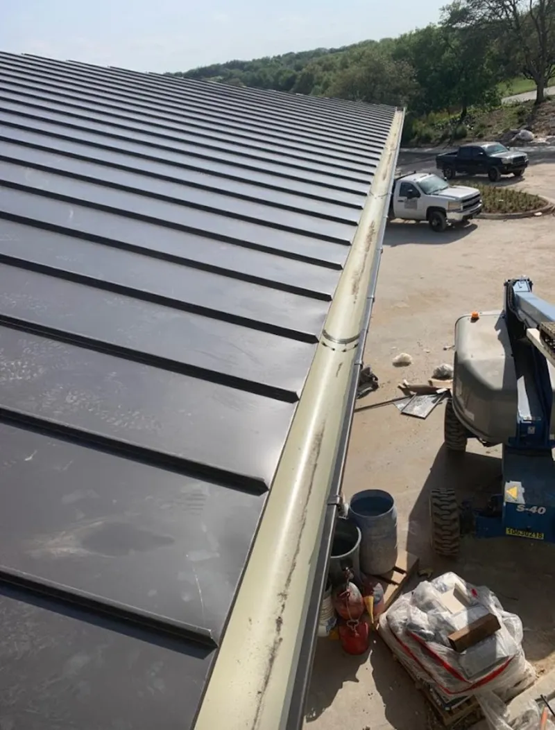 Standing seam panel and gutter detail on a metal roofing jobsite in Newington Forest
